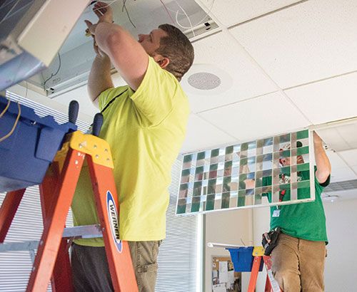 workers install new lighting at Cleveland Clinic