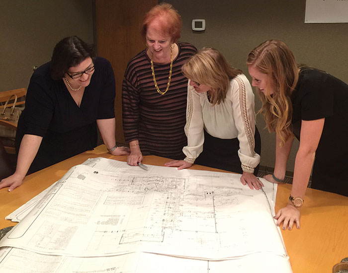 staff looking at blueprints