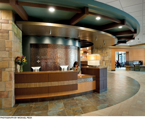 Lobby desk of St. Anthony Hospital.  Wood panels and stone tile highlight the natural environment of Colorado.