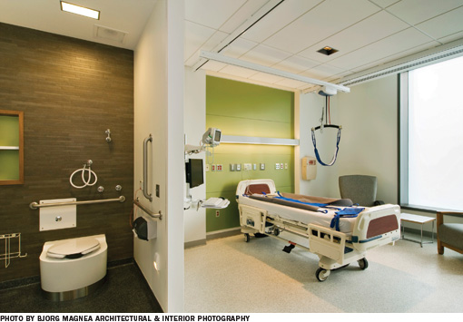 Hospital room with a bedroom on the right, and bathroom on the left, with a wall dividing them