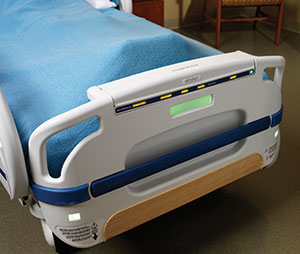 The foot of a modern hospital bed with a small digital display embedded into it