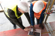 Construction managers looking at laptop