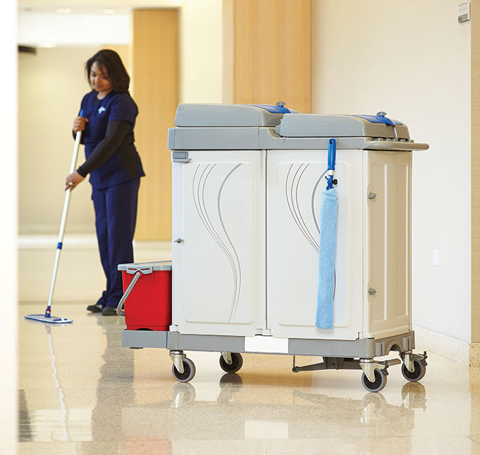 environmental services worker mopping a hospital hallway