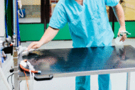 Man wiping hospital table
