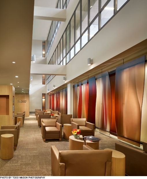 Interior photo of the hospital waiting area with soft chairs and lighting
