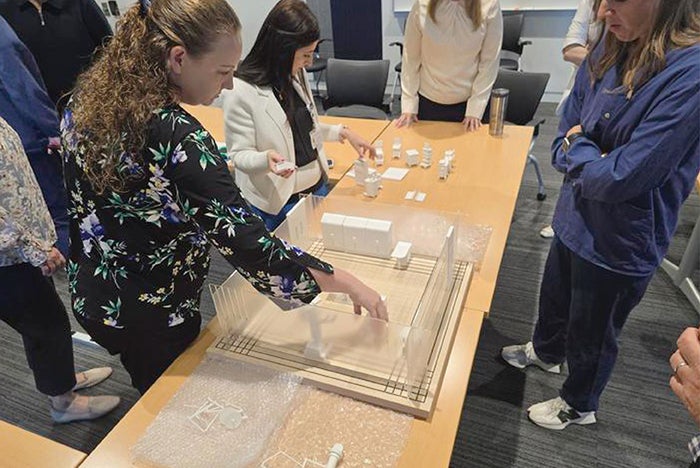 Staff at University of Kentucky Albert B. Chandler Hospital interact with 3D model pieces as part of operating room layout project