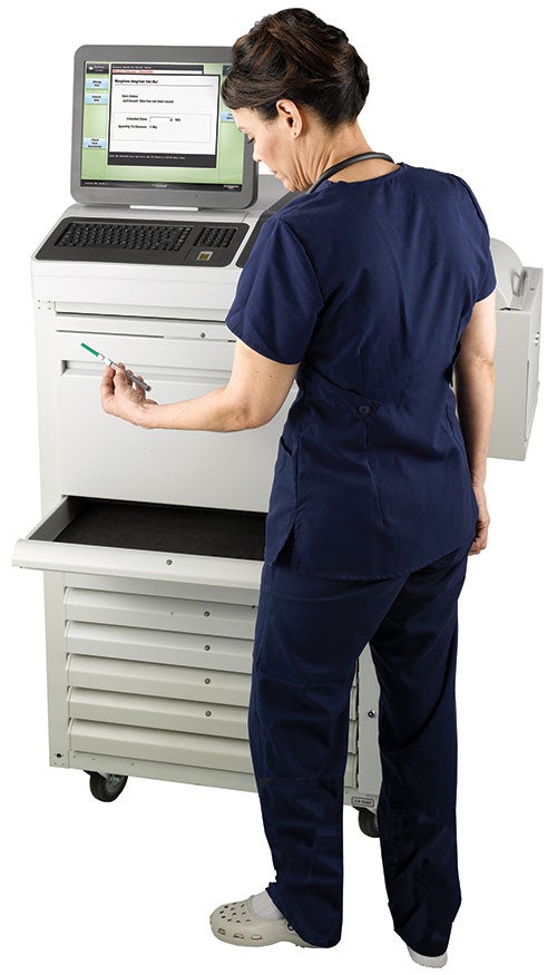 Nurse at medication dispenser