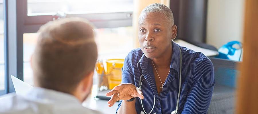 A physician speaks with a coworker to de-escalate a potentially violent situation.