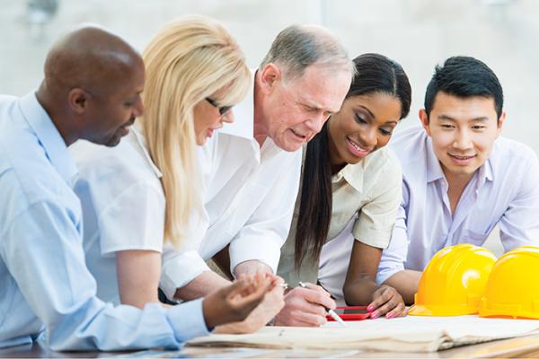Professionals sitting around table brainstorming