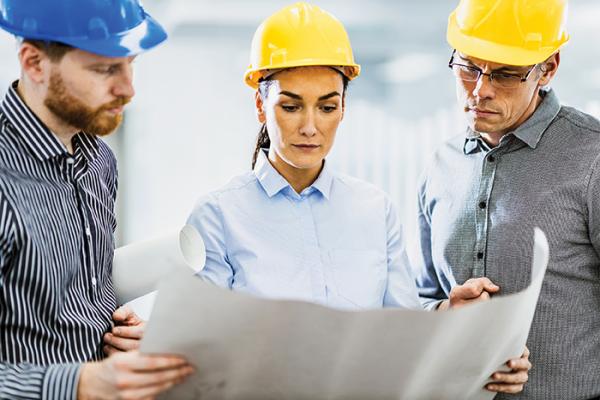 Engineers looking at building plans