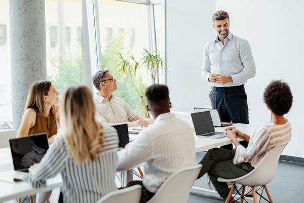 Colleagues sitting around table at meeting