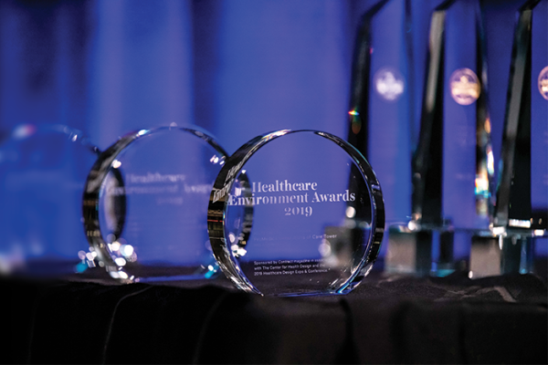 Detail of glass Healthcare Environment Awards trophy on table