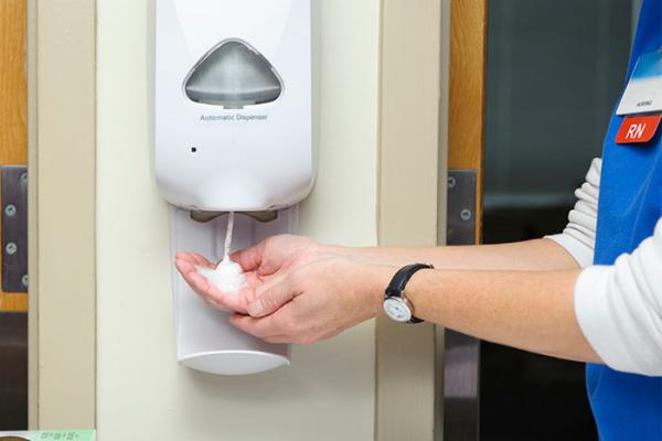RN using soap dispenser