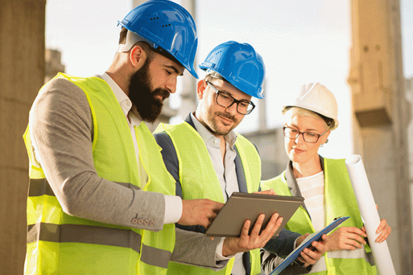 Two men and woman at construction site