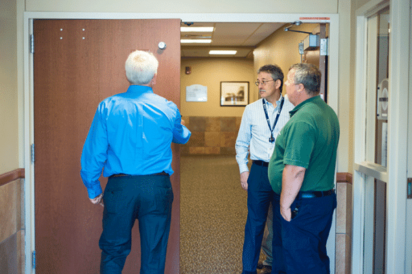 People inspecting hospital door
