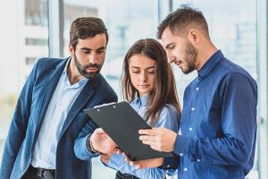 Coworkers looking at tablet