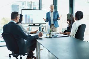 Man presenting to colleagues in business meeting
