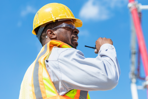 Construction supervisor talking on two-way radio