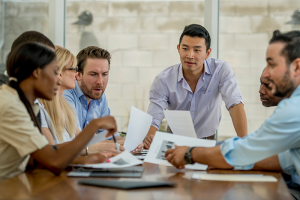 Colleagues sitting around table in business meeting