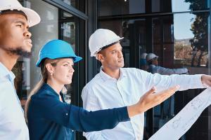 Construction managers looking at plans