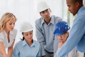 Construction managers looking at plans