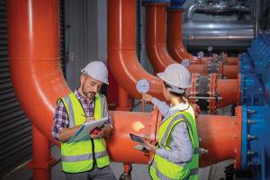 Facilities workers inspecting infrastructure