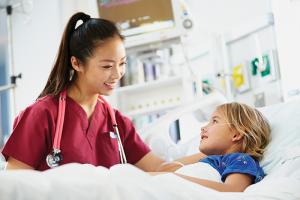 Nurse comforting young patient