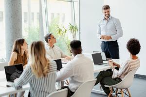 Colleagues sitting around table at meeting