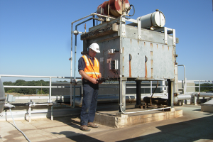 Maintenance worker inspecting rooftop infrastructre