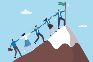 Illustration of employees linked hand in hand climbing up a mountaintop