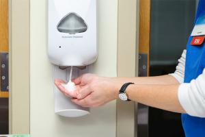 RN using soap dispenser
