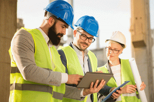 Two men and woman at construction site