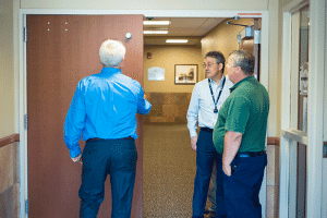 People inspecting hospital door